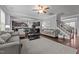 Open-concept living room with a ceiling fan and hardwood floors leading to a kitchen at 184 Elgin Ct, Burlington, NC 27215