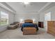 Bright main bedroom with cozy seating area and wood furnishings at 184 Elgin Ct, Burlington, NC 27215