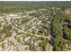 Aerial view of a residential community surrounded by lush greenery and nearby shops at 20002 Fountain, Chapel Hill, NC 27517