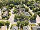 Aerial shot showing a neighborhood with tree-lined streets and manicured lawns on a sunny day at 20002 Fountain, Chapel Hill, NC 27517