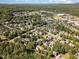 Aerial view of a residential community surrounded by lush greenery and a lake at 20002 Fountain, Chapel Hill, NC 27517