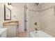 Bathroom showcasing tiled shower over tub and vanity with granite countertop at 20002 Fountain, Chapel Hill, NC 27517