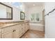 Bright bathroom with double vanity, granite countertops, tub, and shower at 20002 Fountain, Chapel Hill, NC 27517