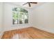 Bright bedroom featuring hardwood floors, large windows and a ceiling fan at 20002 Fountain, Chapel Hill, NC 27517