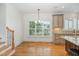 Dining area features hardwood floors, stairs, chandelier, and natural light from plantation shutters at 20002 Fountain, Chapel Hill, NC 27517