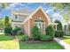 Landscaped yard with a beautiful two-story home featuring brick and siding at 20002 Fountain, Chapel Hill, NC 27517