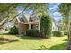 Green home with brick details and well-maintained landscaping at 20002 Fountain, Chapel Hill, NC 27517