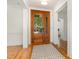 Elegant foyer with hardwood floors, a decorative front door, and white trim, creating a bright and welcoming space at 20002 Fountain, Chapel Hill, NC 27517