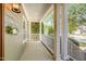 Inviting front porch with classic columns, white railings, and a decorative wreath, creating a welcoming entrance at 20002 Fountain, Chapel Hill, NC 27517