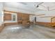 Spacious garage with concrete floors, built-in storage, and brick accents at 20002 Fountain, Chapel Hill, NC 27517