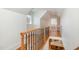 Hallway featuring wooden floors, railings, and an open view of the kitchen below at 20002 Fountain, Chapel Hill, NC 27517