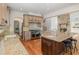 Well-appointed kitchen boasts granite countertops, stainless steel appliances, island with seating, and hardwood flooring at 20002 Fountain, Chapel Hill, NC 27517