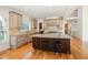 Spacious kitchen boasts an island with seating, custom cabinets, and stainless steel appliances at 20002 Fountain, Chapel Hill, NC 27517