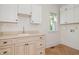 Laundry room featuring a sink, window, and ample cabinet space at 20002 Fountain, Chapel Hill, NC 27517