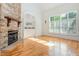 Bright living room features hardwood floors, stone fireplace, and large windows with shutters at 20002 Fountain, Chapel Hill, NC 27517