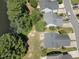 Aerial view of a street with houses near a lush wooded area at 2053 Thornblade Dr, Raleigh, NC 27604