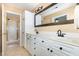 Bathroom with double sink vanity, tile floors, and a glass enclosed shower at 2053 Thornblade Dr, Raleigh, NC 27604