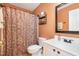 Bathroom features patterned shower curtain, white vanity, and decorative mirror at 2053 Thornblade Dr, Raleigh, NC 27604