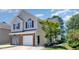 Charming two-story home with a brick-accented garage and well-maintained landscaping at 2053 Thornblade Dr, Raleigh, NC 27604
