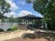 Picturesque gazebo overlooking a tranquil lake, surrounded by flowers and lush greenery at 2053 Thornblade Dr, Raleigh, NC 27604