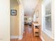 Hallway with laminate floors, windows, console table, and access to living room at 2053 Thornblade Dr, Raleigh, NC 27604
