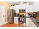 Modern kitchen with stainless steel appliances and ample counter space for meal preparation at 2053 Thornblade Dr, Raleigh, NC 27604
