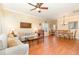 Inviting living room with hardwood floors, a ceiling fan and a view into the dining area at 2053 Thornblade Dr, Raleigh, NC 27604