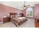 Main bedroom with vaulted ceiling, large window, desk, and ceiling fan at 2053 Thornblade Dr, Raleigh, NC 27604