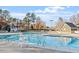 Large swimming pool area for relaxing on a sunny day with poolside buildings at 2053 Thornblade Dr, Raleigh, NC 27604