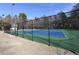 Brightly colored tennis court is surrounded by a tall black fence at 2053 Thornblade Dr, Raleigh, NC 27604