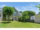 Spacious backyard featuring lush lawn, mature trees, and a view of the green exterior of the home at 2112 Dunn Rd, Raleigh, NC 27614