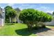 Well-maintained backyard with lush green grass, mature trees, and the exterior of the house at 2112 Dunn Rd, Raleigh, NC 27614