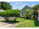 Lawn and backyard with a stepping stone path, large trees, and partial view of the home's exterior at 2112 Dunn Rd, Raleigh, NC 27614
