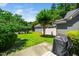 Backyard with grass, various trees, a Weber grill, and a detached garage at 2112 Dunn Rd, Raleigh, NC 27614