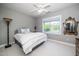 Cozy bedroom with ceiling fan, large window, and neutral decor at 2112 Dunn Rd, Raleigh, NC 27614