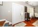 Entryway featuring hardwood floors, a white front door, and a decorative table at 2112 Dunn Rd, Raleigh, NC 27614