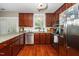 Bright kitchen with stainless steel appliances, granite countertops, and wood floors at 2112 Dunn Rd, Raleigh, NC 27614
