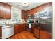 Kitchen with stainless steel appliances, granite countertops, and wood cabinets at 2112 Dunn Rd, Raleigh, NC 27614
