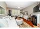 Cozy living room featuring neutral tones, a fireplace, and a large window at 2112 Dunn Rd, Raleigh, NC 27614