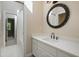 Bathroom with decorative mirror, white vanity, and a view of the shower/tub at 217 Dalmeny Dr, Cary, NC 27513
