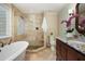 Elegant bathroom featuring a glass enclosed shower and a soaking tub, offering a spa-like experience at 217 Dalmeny Dr, Cary, NC 27513