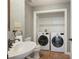 Functional bathroom featuring a washing machine, dryer, sink, and toilet for added convenience at 217 Dalmeny Dr, Cary, NC 27513
