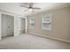 Bright bedroom with carpet, neutral walls, ceiling fan, and natural light at 217 Dalmeny Dr, Cary, NC 27513