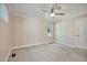 Bright, carpeted bedroom with a ceiling fan, a window, neutral colors, and painted white trim at 217 Dalmeny Dr, Cary, NC 27513