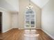 Bright dining area with hardwood floors, a large window, and elegant chandelier at 217 Dalmeny Dr, Cary, NC 27513