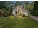 Charming two-story home with a brick facade, well-manicured lawn, and mature landscaping at 217 Dalmeny Dr, Cary, NC 27513