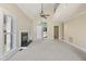Open living room with a fireplace, tall ceilings, a ceiling fan, and natural light at 217 Dalmeny Dr, Cary, NC 27513