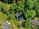 An aerial view reveals a home nestled among mature trees, providing shade and privacy in a tranquil setting at 221 Antique Lace Way, Holly Springs, NC 27540