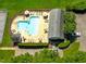 Aerial view highlighting community pool with lounge area and a well-maintained parking lot at 221 Antique Lace Way, Holly Springs, NC 27540