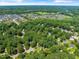 Beautiful aerial view of a neighborhood with mature trees and a serene setting at 221 Antique Lace Way, Holly Springs, NC 27540